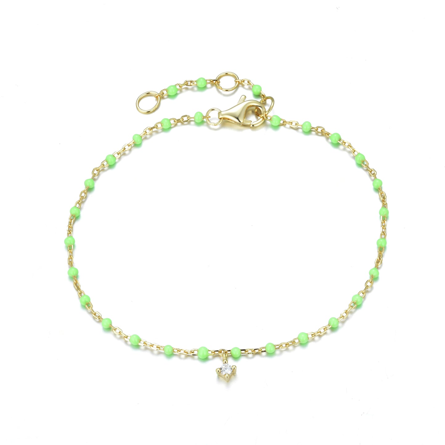 Gold-plated chain and apple green enamel bead bracelet with a hanging cubic zirconia stone.