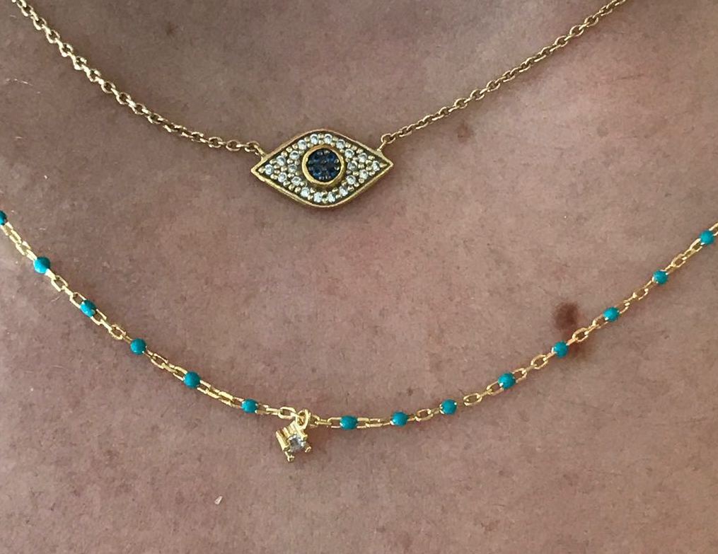 Gold-plated short chain and turquoise bead necklace with a central Cubic Zirconia stone.
