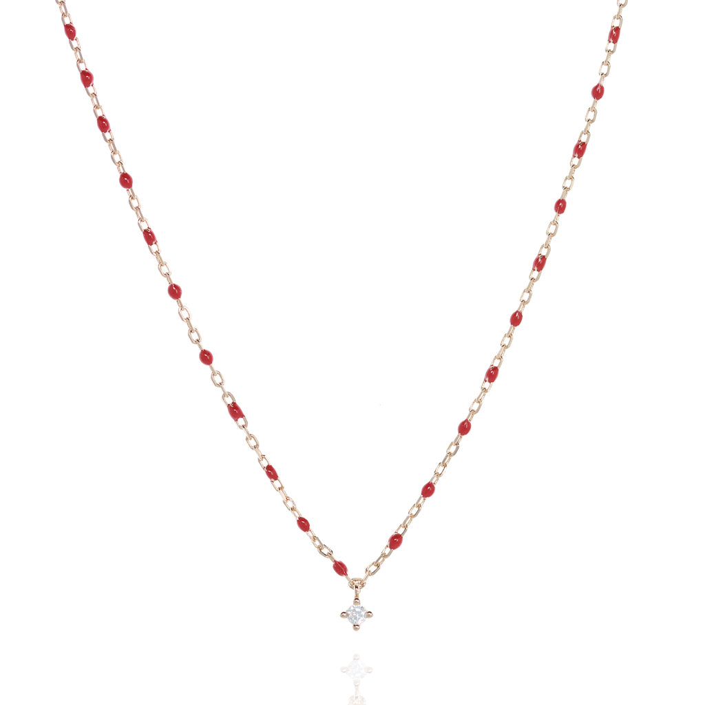 Rose gold plated sterling silver short necklace with red beads and central Cubic Zirconia gem.