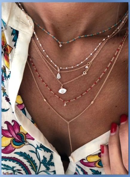 Sterling silver short chain necklace with red beads and a central small Cubic Zirconia.