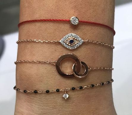
Rose gold plated chain and bead bracelet with small hanging cubic zirconia, featuring black beads and a lobster claw clasp.

